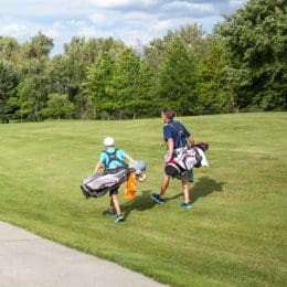 golfer and caddy on course